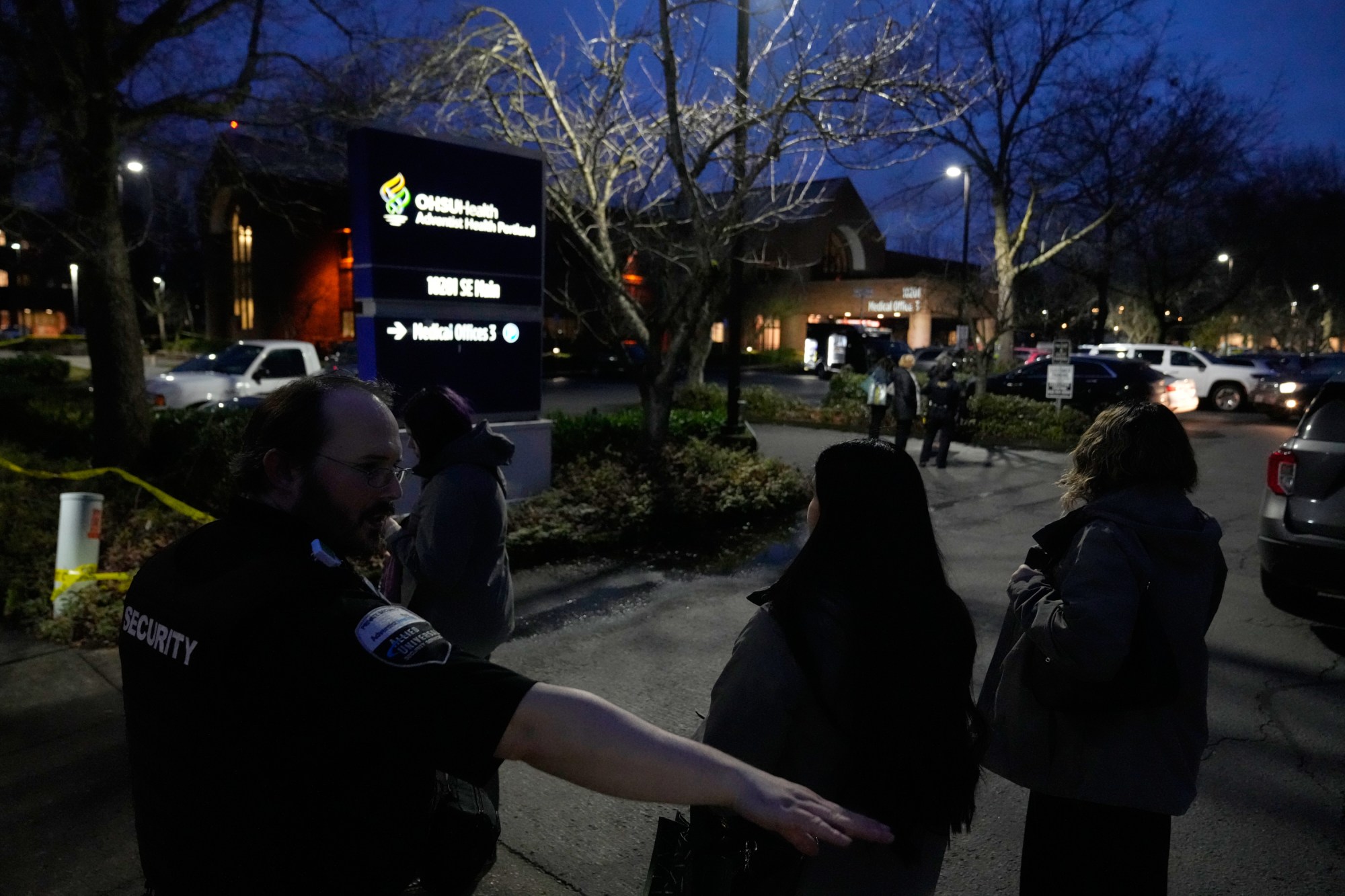 A security guard stands at the scene following reports that federal immigration officers shot and wounded people in Portland, Ore., Thursday, Jan. 8, 2026. (AP Photo/Jenny Kane)
